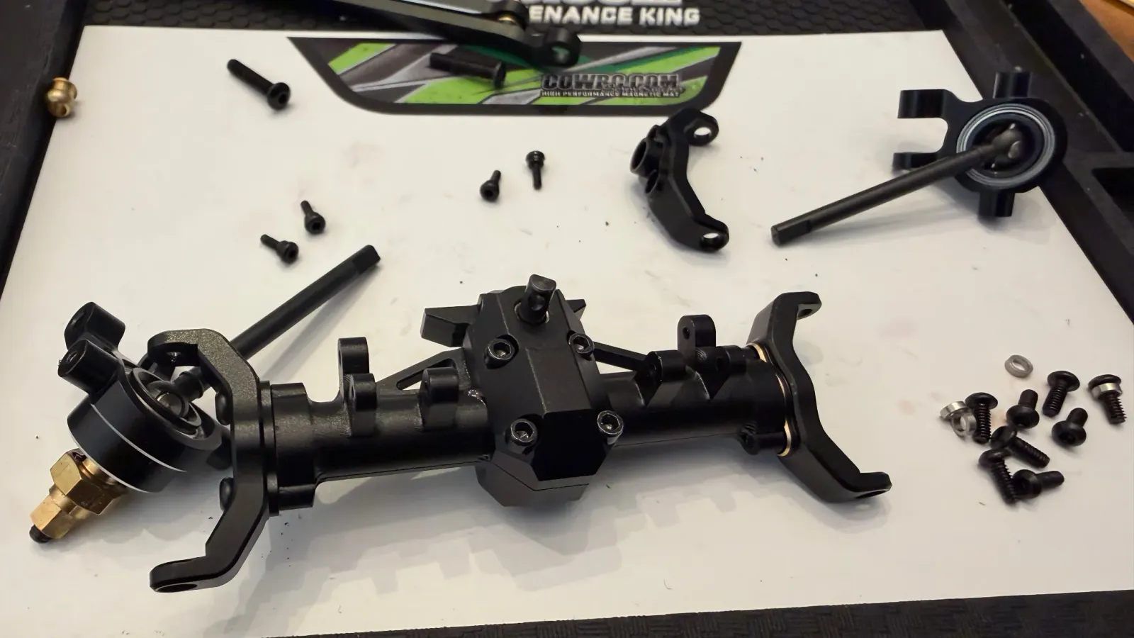 An SCX24 portal axle taken apart on a work mat