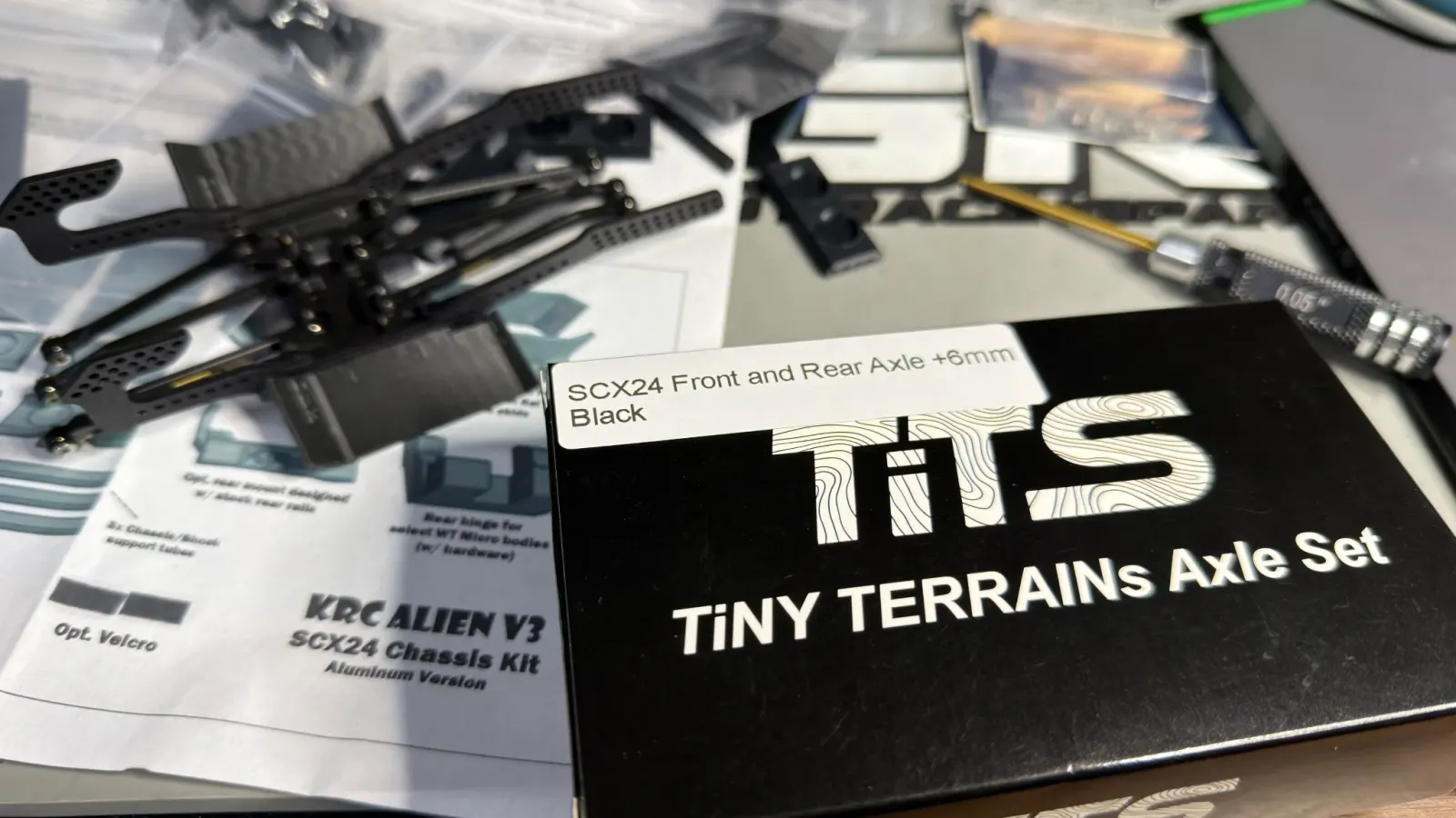 Tiny Terrains TiTS axle set box next to a KRC chassis kit