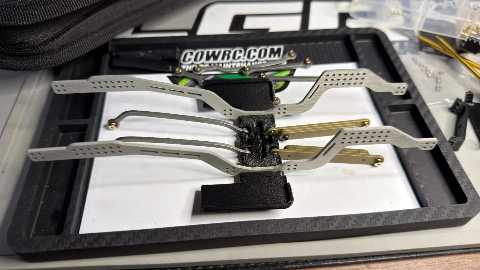 Aluminum LCG chassis rails and links laid out on a work mat