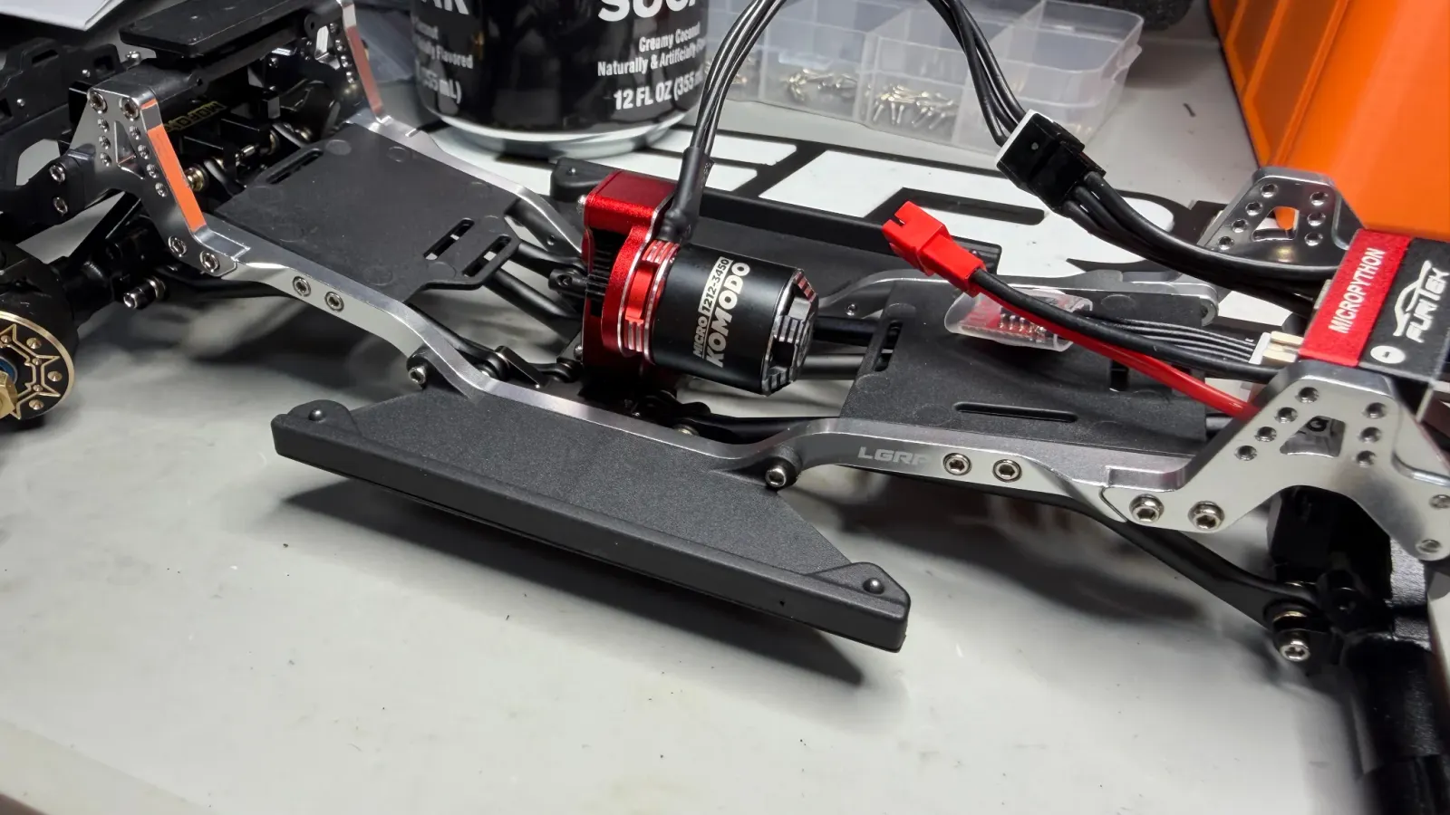 A red brushless motor and ESC on an aluminum SCX24 chassis