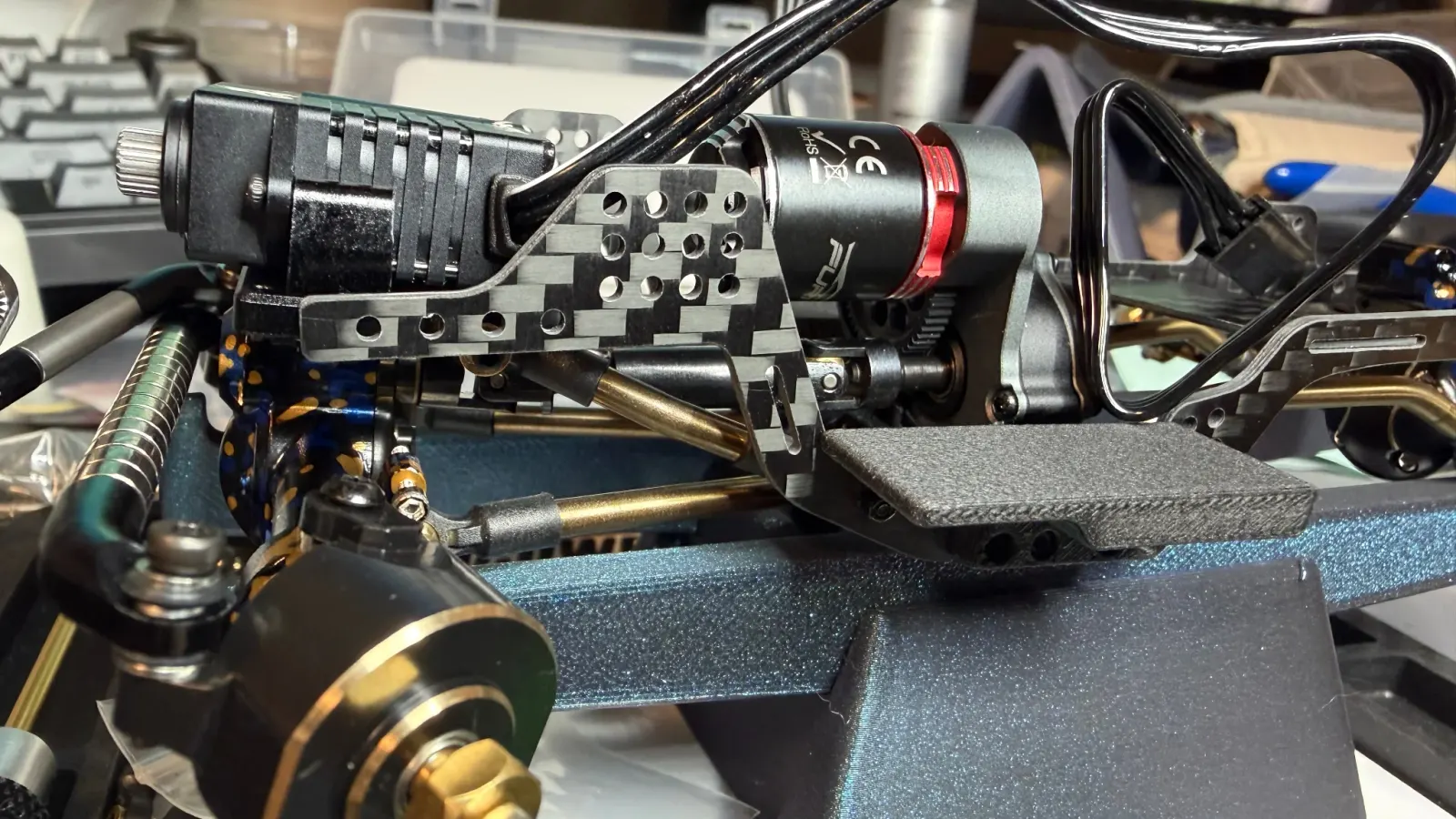 A brushless motor installed on a carbon fiber SCX24 chassis