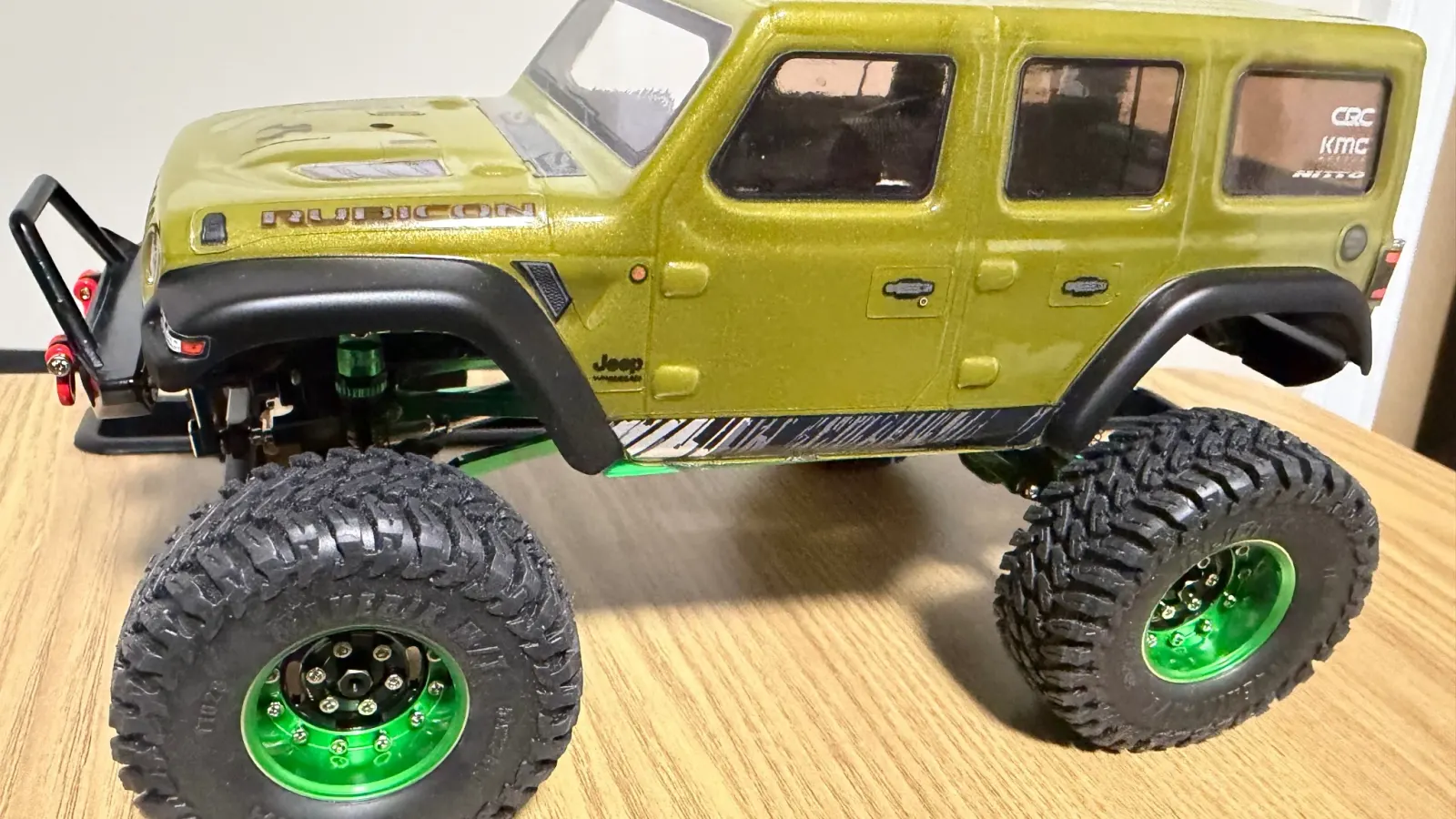 A green JLU on green beadlock wheels and upgraded tires