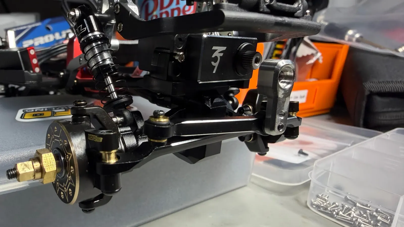 An upgraded servo mounted on the front axle of an SCX24