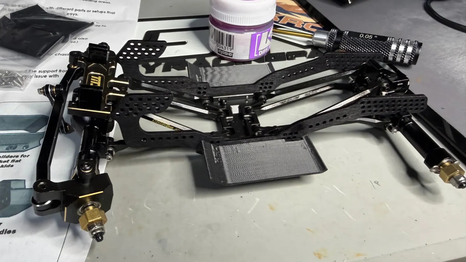 Hex drivers, grease, and a chassis in progress on the bench